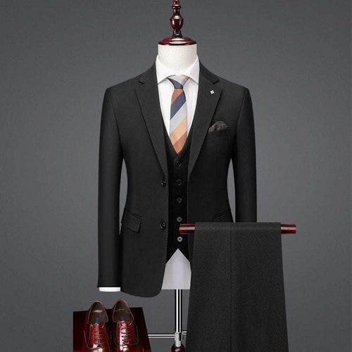 Handsome slim fit British style business casual suit with tie, shoes, and pants displayed on a mannequin.