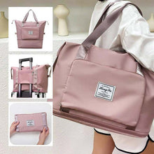 Load image into Gallery viewer, Foldable pink waterproof travel bag with large capacity and suitcase strap, designed for women.
