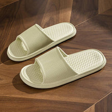 Load image into Gallery viewer, Rhombus striped non-slip bathroom slippers in solid color on wooden floor.
