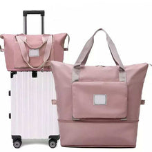 Load image into Gallery viewer, Waterproof foldable travel bag in pink, large capacity, suitcase attachment feature, ideal for women.
