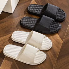 Load image into Gallery viewer, Non-slip rhombus striped bathroom slippers in solid colors for men and women, featuring a breathable EVA upper and foam sole.
