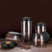 Load image into Gallery viewer, Vacuum sealed glass canisters with black lids, storing coffee beans. Airtight storage jars for kitchen use.
